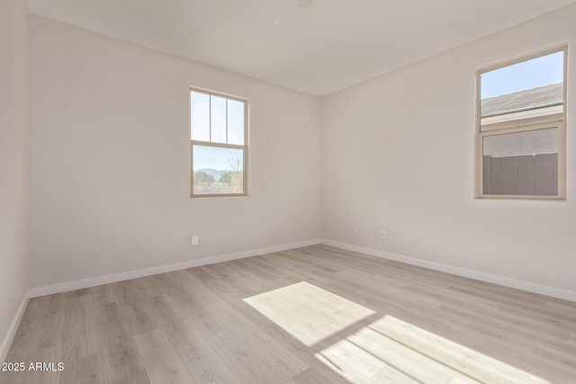 spare room featuring light hardwood / wood-style floors