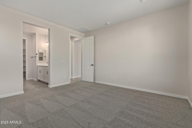 unfurnished bedroom with light carpet and ensuite bathroom