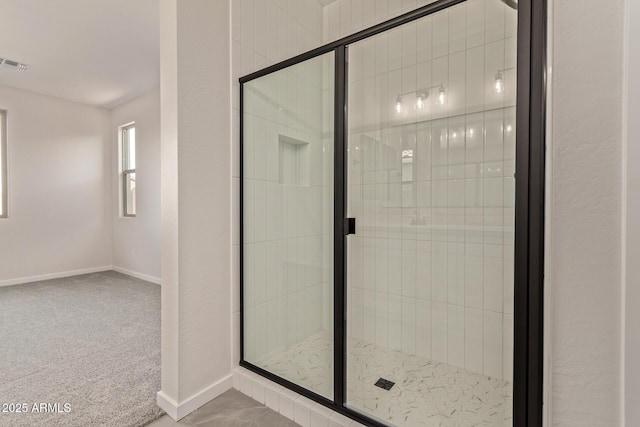 bathroom featuring a shower with shower door