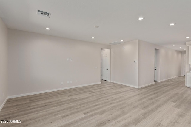 unfurnished room with light wood-type flooring