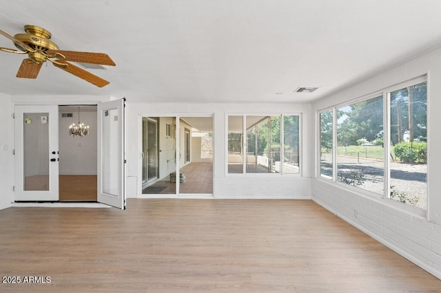11220 N 109th Ave, Sun City, AZ 85351 - unfurnished sunroom featuring wood finished floors and a chandelier