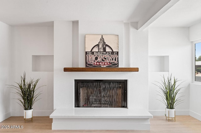 11220 N 109th Ave, Sun City, AZ 85351 - detailed view of wood finished floors, a fireplace with raised hearth, and baseboards