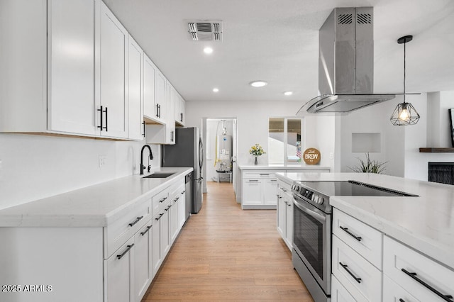 11220 N 109th Ave, Sun City, AZ 85351 - kitchen with island exhaust hood, stainless steel appliances, a sink, light wood-style floors, and white cabinetry