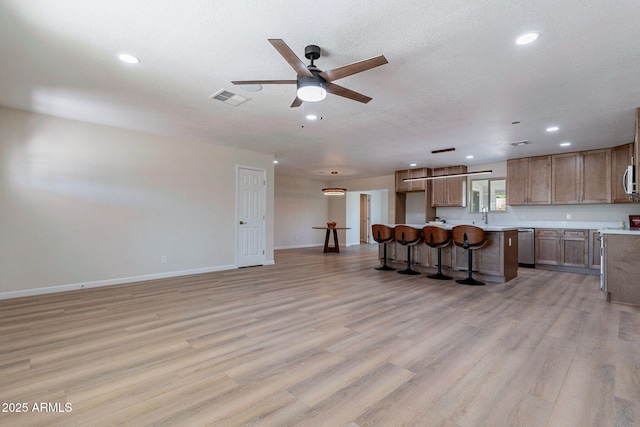 1210 W La Jolla Dr, Tempe, AZ 85282 - living area with ceiling fan, recessed lighting, light wood-style floors, and a textured ceiling