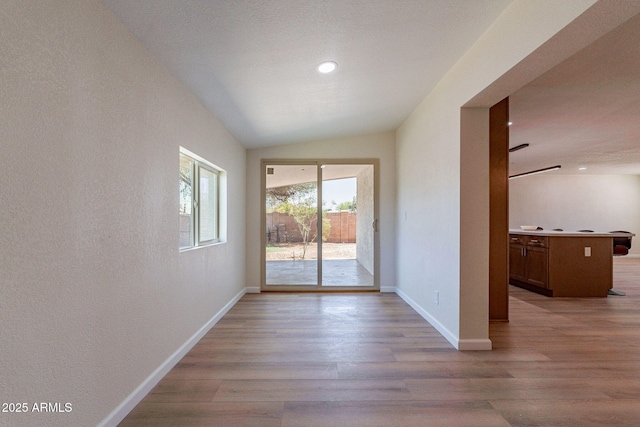 1210 W La Jolla Dr, Tempe, AZ 85282 - unfurnished room featuring light wood finished floors, vaulted ceiling, and recessed lighting