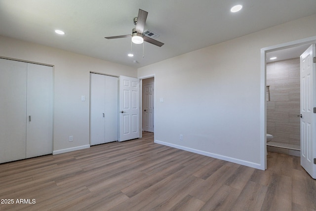 1210 W La Jolla Dr, Tempe, AZ 85282 - unfurnished bedroom with multiple closets, light wood-style floors, ensuite bath, recessed lighting, and a ceiling fan