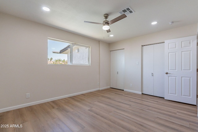 1210 W La Jolla Dr, Tempe, AZ 85282 - unfurnished bedroom with multiple closets, light wood-type flooring, recessed lighting, and ceiling fan