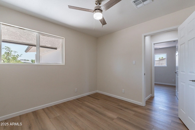 1210 W La Jolla Dr, Tempe, AZ 85282 - empty room with light wood-style floors and a ceiling fan