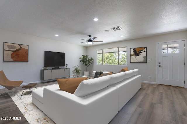 1210 W La Jolla Dr, Tempe, AZ 85282 - living room featuring a textured ceiling, wood finished floors, recessed lighting, and a ceiling fan