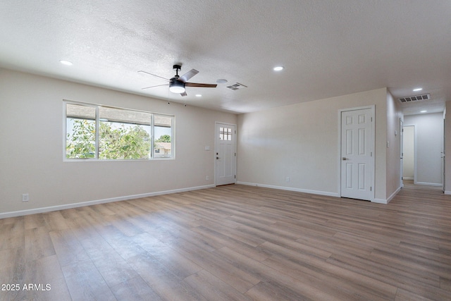 1210 W La Jolla Dr, Tempe, AZ 85282 - empty room with ceiling fan, wood finished floors, recessed lighting, and a textured ceiling