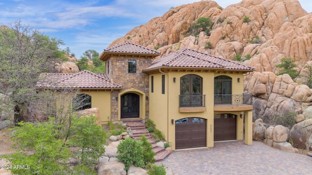 4393 N Twisted Trl, Prescott, AZ 86301 - mediterranean / spanish home featuring a balcony, a tiled roof, decorative driveway, an attached garage, and stucco siding