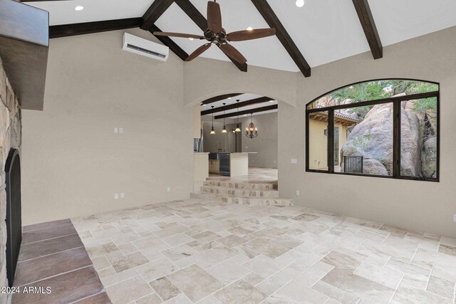 4393 N Twisted Trl, Prescott, AZ 86301 - unfurnished living room with high vaulted ceiling, arched walkways, beam ceiling, ceiling fan, and stone finish flooring