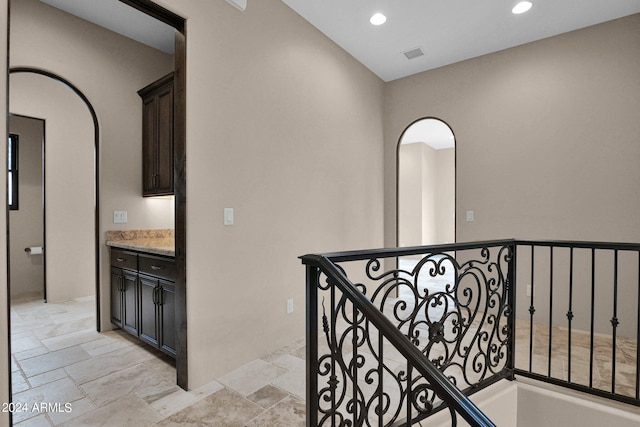 4393 N Twisted Trl, Prescott, AZ 86301 - corridor featuring an upstairs landing, stone tile flooring, visible vents, arched walkways, and recessed lighting