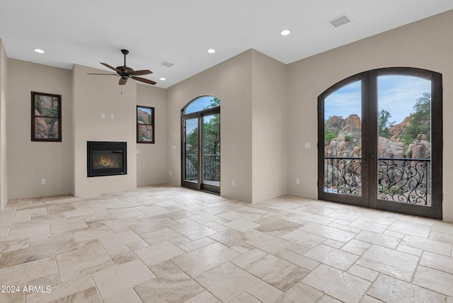4393 N Twisted Trl, Prescott, AZ 86301 - unfurnished living room featuring visible vents, recessed lighting, a ceiling fan, a glass covered fireplace, and french doors