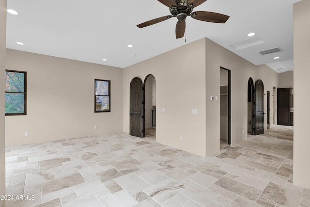 4393 N Twisted Trl, Prescott, AZ 86301 - empty room featuring visible vents, stone finish flooring, ceiling fan, recessed lighting, and arched walkways