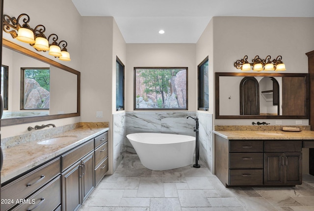 4393 N Twisted Trl, Prescott, AZ 86301 - full bath featuring stone tile floors, a wainscoted wall, a sink, a freestanding bath, and two vanities