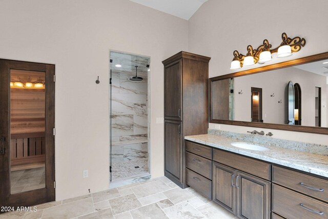 4393 N Twisted Trl, Prescott, AZ 86301 - bathroom featuring vaulted ceiling, a stall shower, vanity, and stone finish flooring