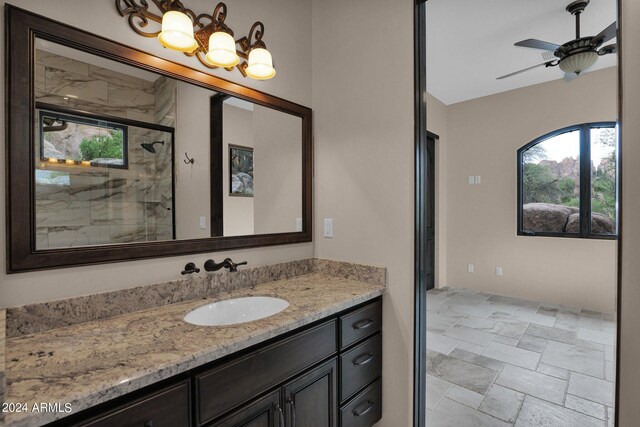 4393 N Twisted Trl, Prescott, AZ 86301 - full bathroom featuring vanity, a wealth of natural light, a stall shower, and stone tile flooring