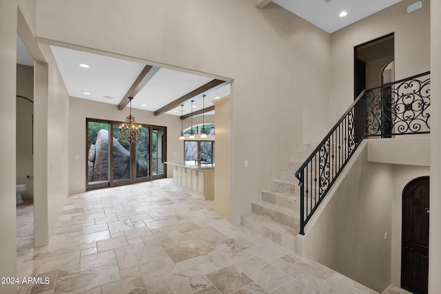 4393 N Twisted Trl, Prescott, AZ 86301 - stairs featuring stone tile flooring, beamed ceiling, arched walkways, recessed lighting, and an inviting chandelier