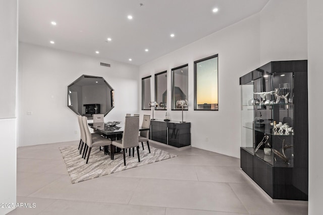 tiled dining area with recessed lighting and visible vents