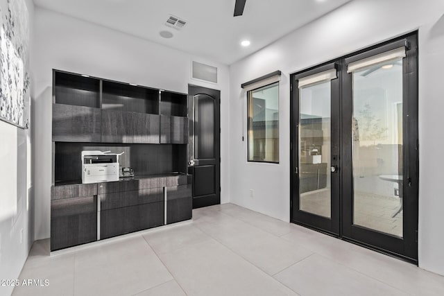 kitchen featuring visible vents, modern cabinets, dark cabinets, and light tile patterned flooring