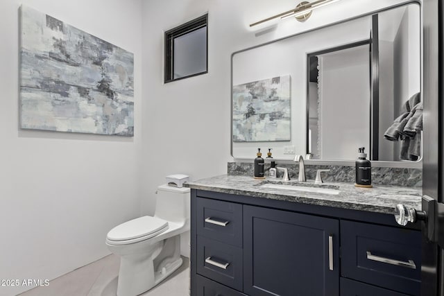 bathroom with vanity, toilet, and tile patterned flooring