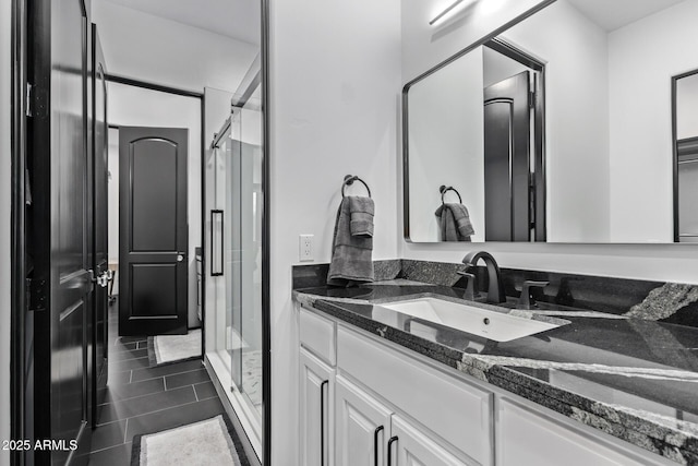 full bathroom featuring a stall shower and vanity