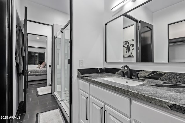 full bathroom featuring connected bathroom, vanity, and a shower stall