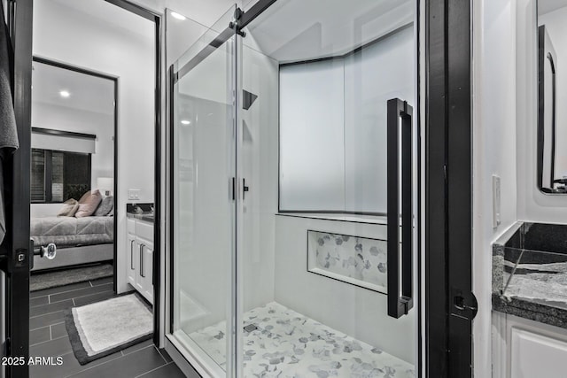 full bathroom with a shower stall, vanity, and ensuite bathroom