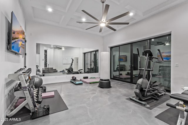 gym featuring a towering ceiling, a ceiling fan, recessed lighting, and coffered ceiling