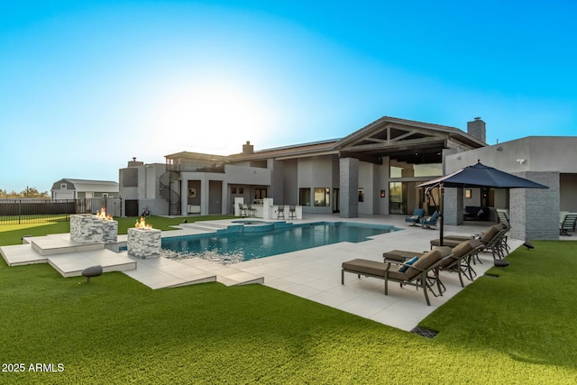 view of pool featuring a patio, an outdoor fire pit, a yard, and fence