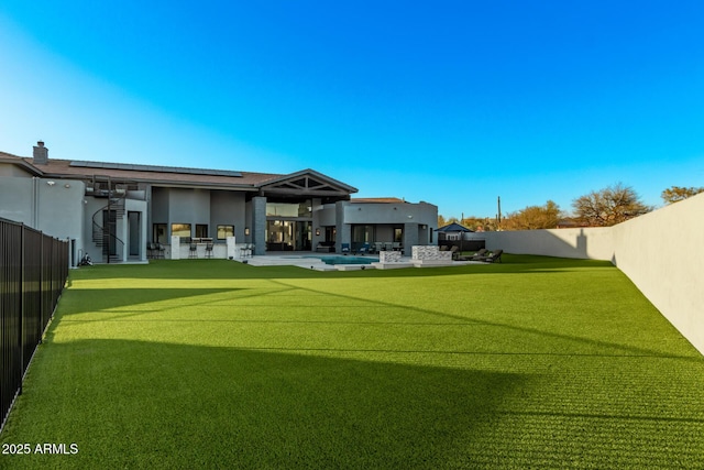 view of yard with a fenced in pool, a fenced backyard, and a patio area