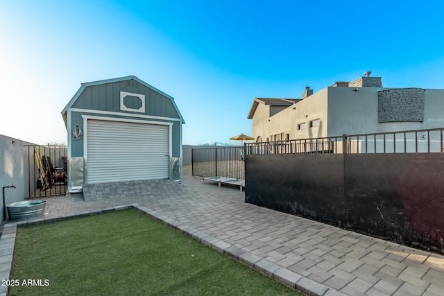 exterior space with an outdoor structure and a fenced backyard