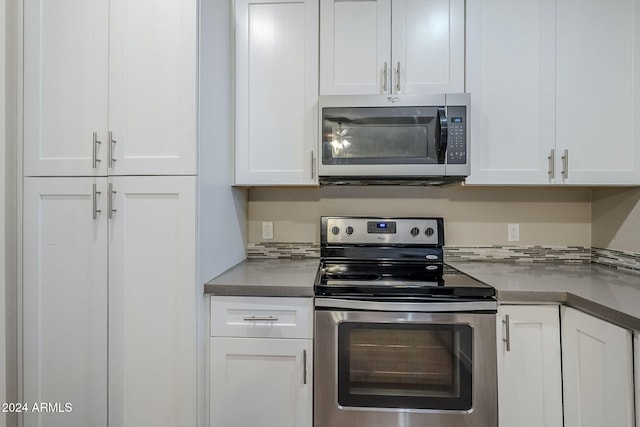 kitchen featuring white cabinets and appliances with stainless steel finishes