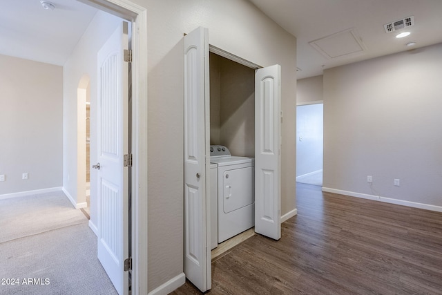 laundry room featuring washer / clothes dryer and wood-type flooring