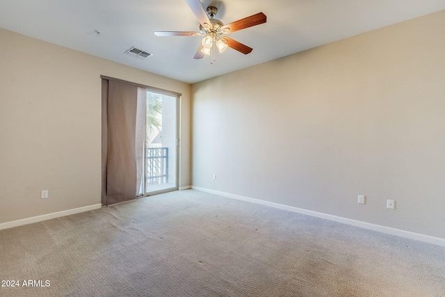 carpeted spare room with ceiling fan