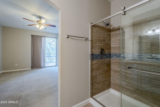 bathroom featuring ceiling fan and an enclosed shower