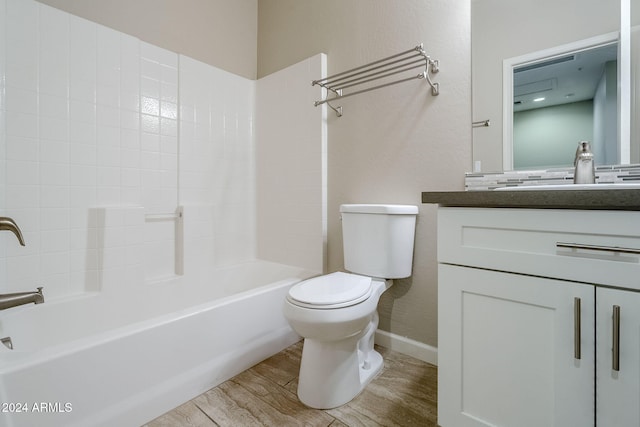 full bathroom featuring shower / bathing tub combination, wood-type flooring, vanity, and toilet