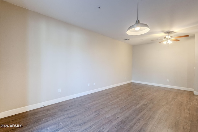 unfurnished room with ceiling fan and wood-type flooring