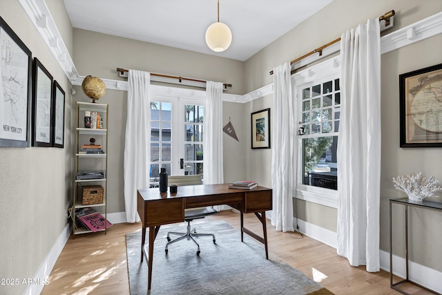 office with light wood-style floors and baseboards