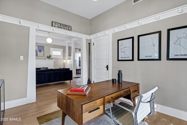 home office featuring baseboards and wood finished floors