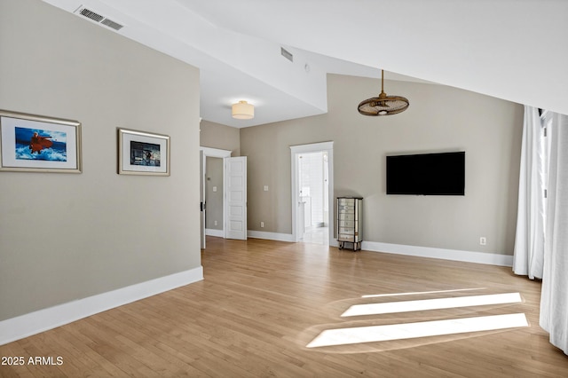 unfurnished living room featuring light wood-type flooring, visible vents, and baseboards