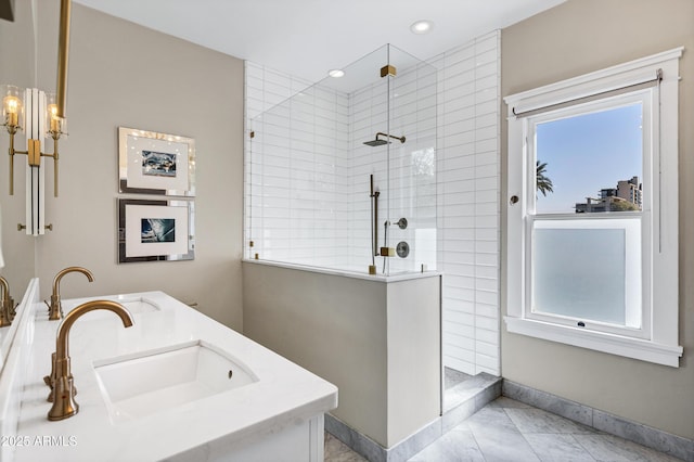 full bathroom with recessed lighting, a sink, baseboards, and walk in shower