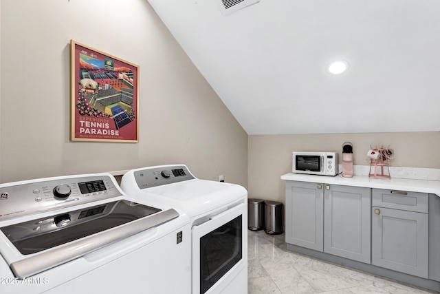 laundry area with marble finish floor, separate washer and dryer, cabinet space, and visible vents