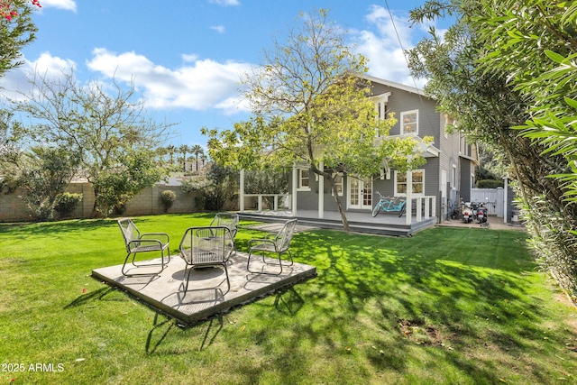 view of yard with a patio area, a fenced backyard, and a wooden deck