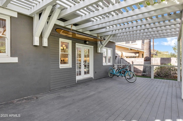 wooden deck with french doors, fence, and a pergola