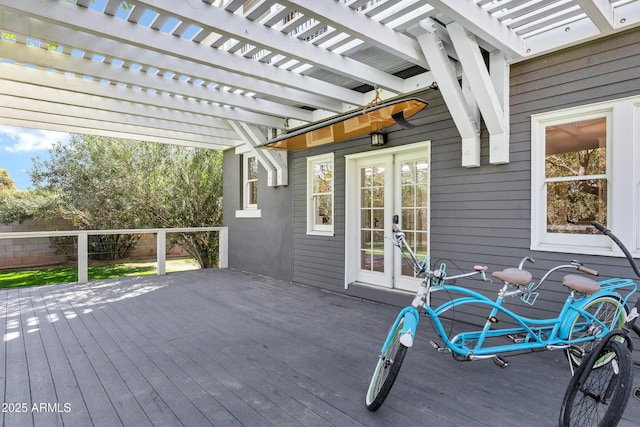 wooden terrace with french doors, fence, and a pergola