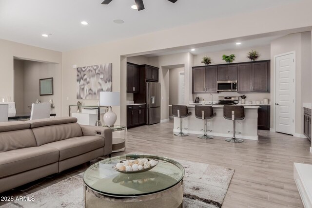 3852 E Bartlett Way, Chandler, AZ 85249 - living area featuring light wood finished floors, ceiling fan, recessed lighting, and baseboards