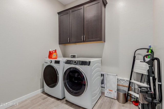 3852 E Bartlett Way, Chandler, AZ 85249 - laundry area with washer and clothes dryer, cabinet space, light wood-style flooring, and baseboards