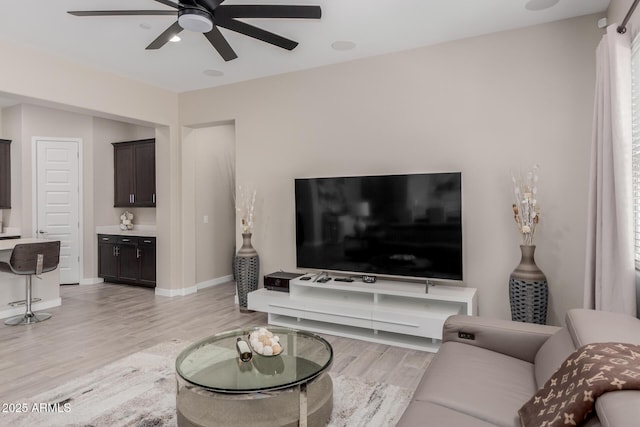 3852 E Bartlett Way, Chandler, AZ 85249 - living area with light wood finished floors, a ceiling fan, and baseboards